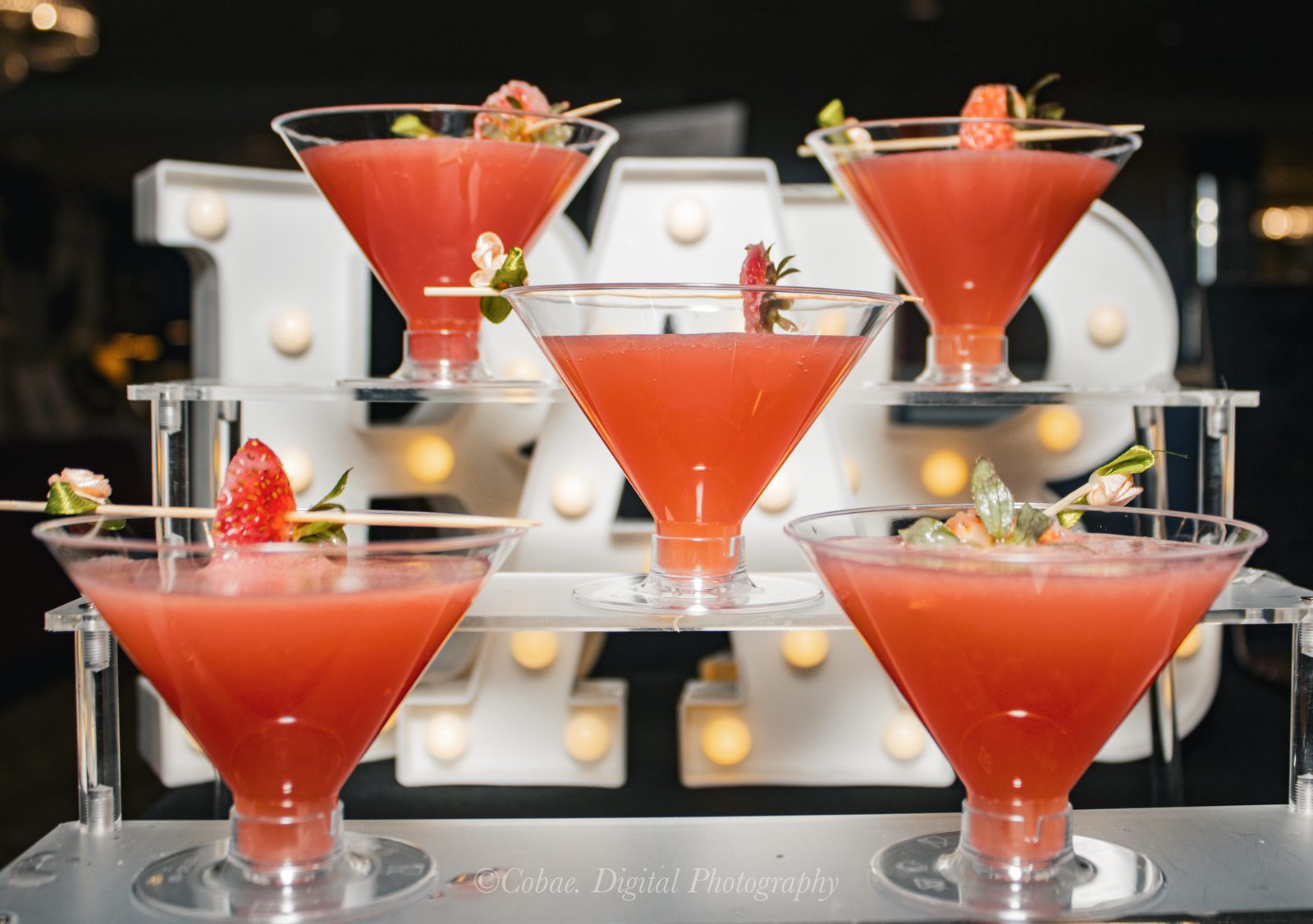 Strawberry martinis, batched and poured to order