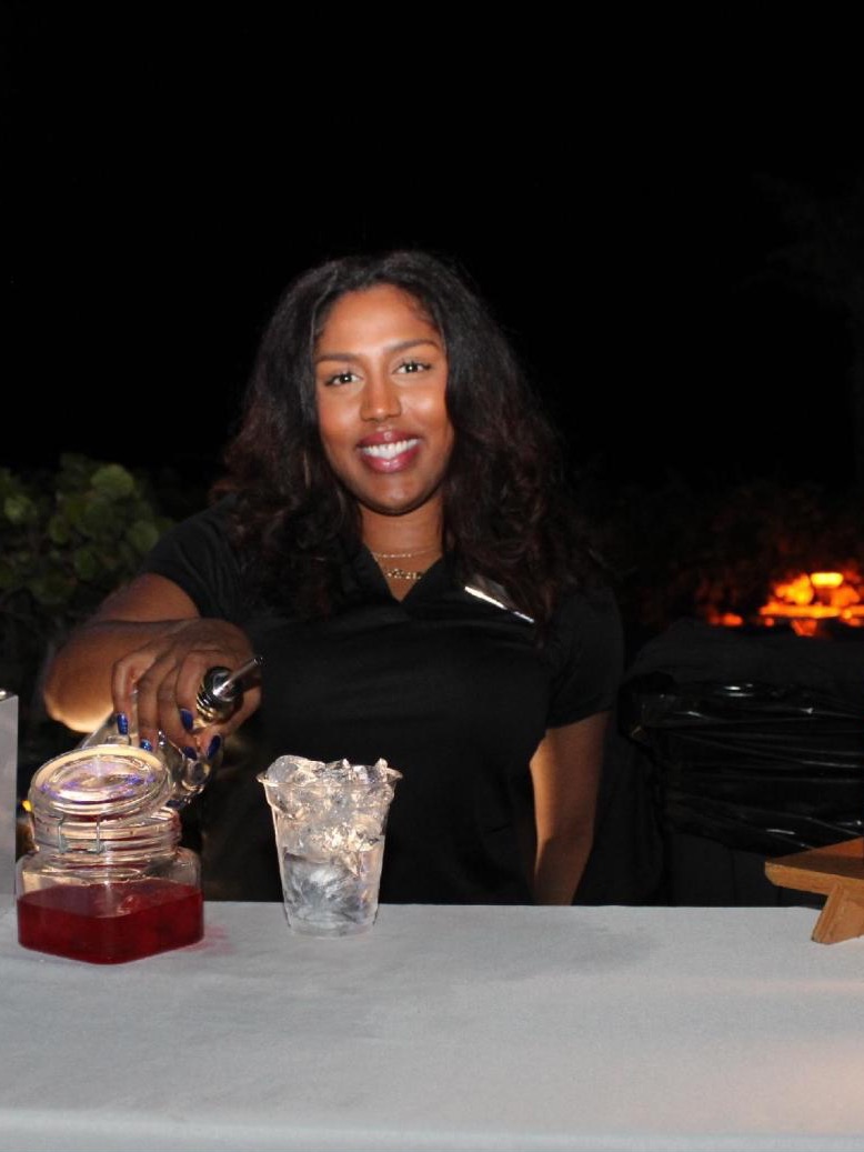 Rosie pouring at the South Florida Claims Association Miami Vice holiday party, 2024